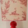 A handmade lampshade with French Toile de Jouy fabric in pink