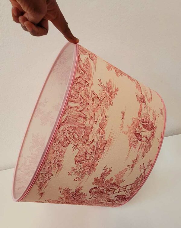 A handmade lampshade with French Toile de Jouy fabric in pink